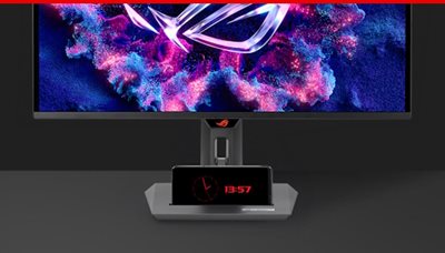 Die Vorderseite des XG27ACDNG mit einem Mobiltelefon auf der Gerätenut